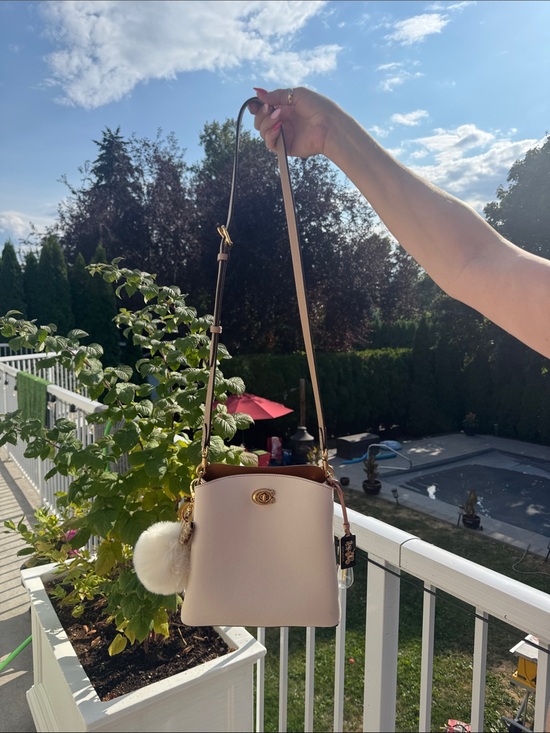 Coach Handbags - Coach Light Cream Pebbled Leather Crossbody Bucket Bag with Pom Pom
